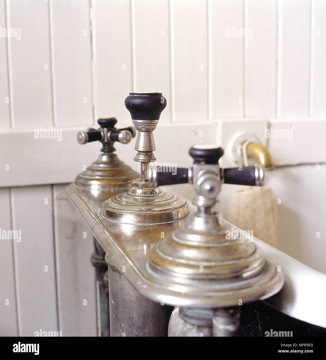 Bathroom detail victorian fittings taps cast iron bath wood panelled