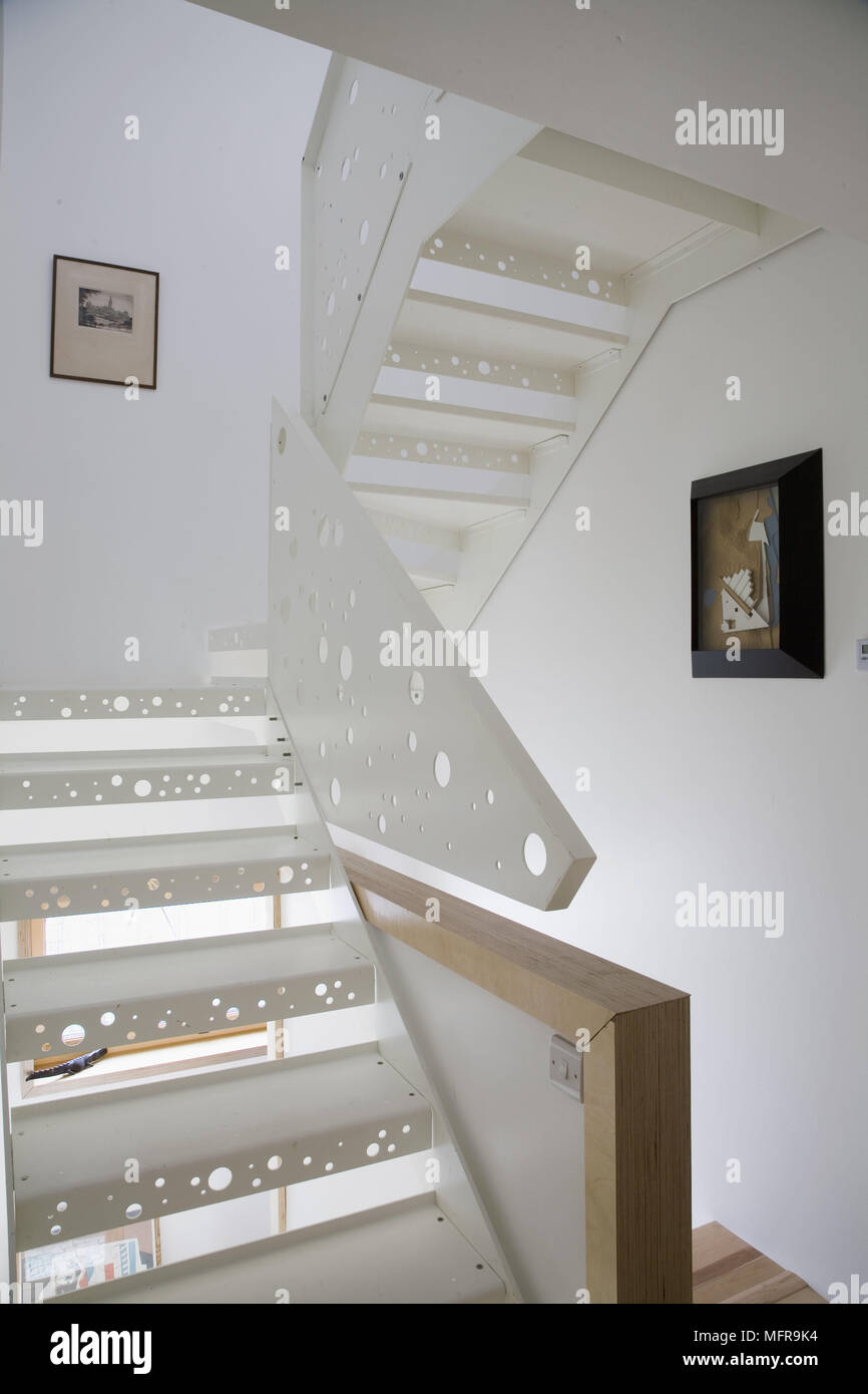 Contemporary Staircase With Light Shining Through Holes Cut