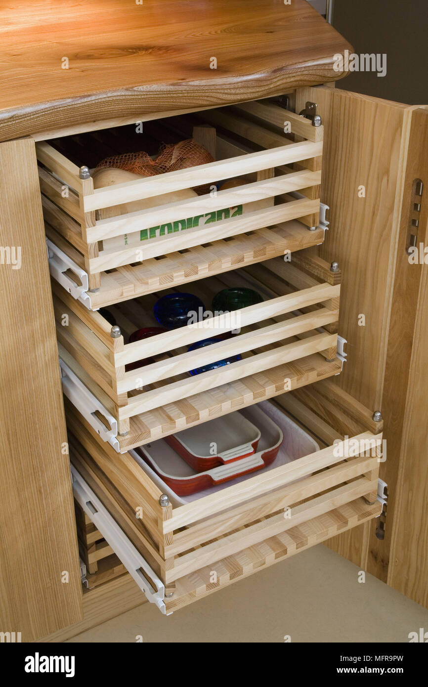 Food And Tableware Stored In Wooden Pullout Drawers In Pine Wood