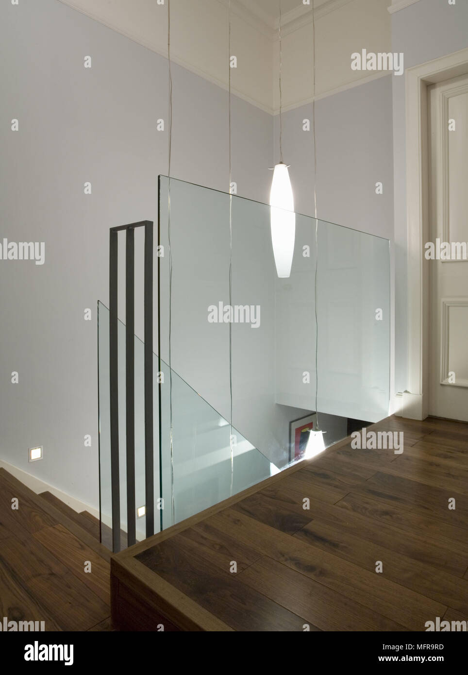Glass Screen At Top Of Stairs On Landing With Wooden Floor Stock