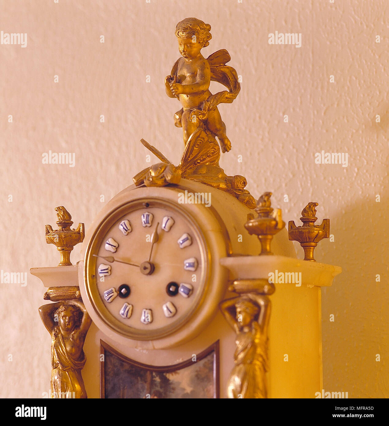 Sitting room detail antique gold clock chreubs Interiors clocks ornaments antiques period Stock Photo