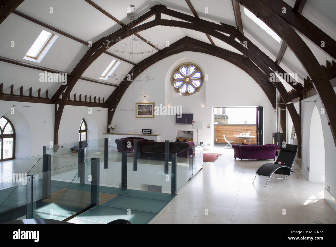 Spacious sitting room area in upper floor of converted church Stock Photo