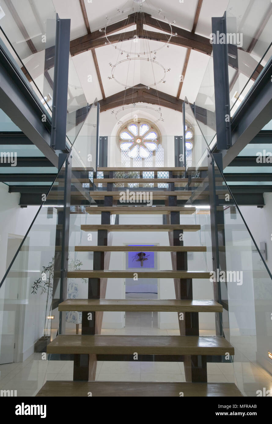 View from below of open plan staircase in centre of converted church Stock Photo
