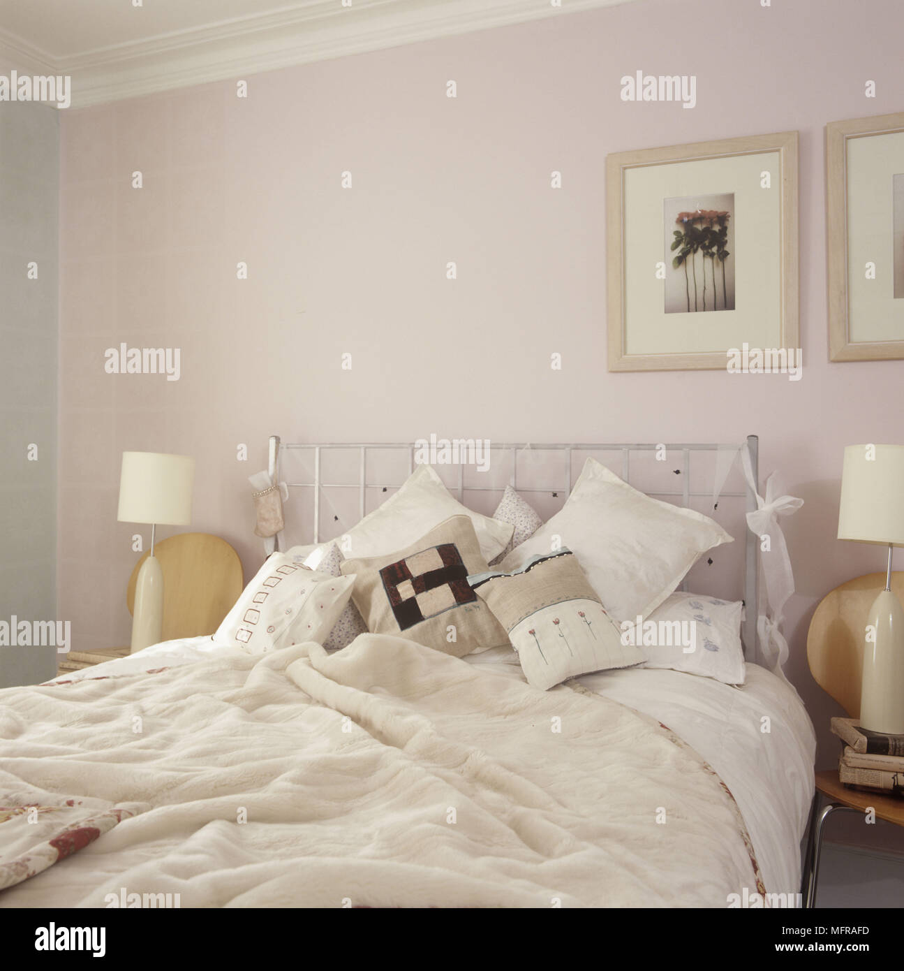 A Detail Of A Pastel Coloured Country Bedroom With Cushions