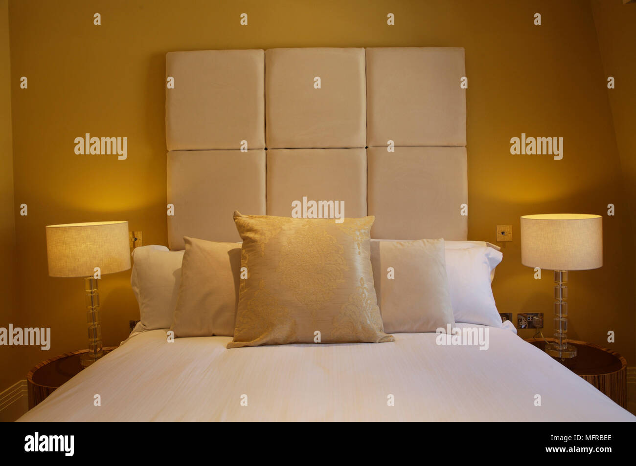 Double bed with padded headboard and cushions Stock Photo Alamy