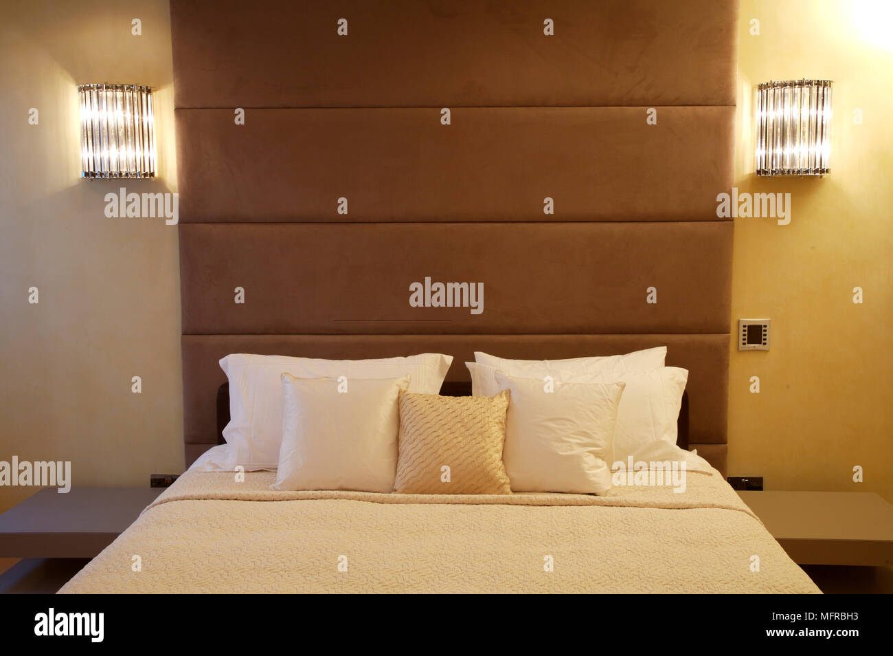 Master bedroom with padded headboard Stock Photo Alamy