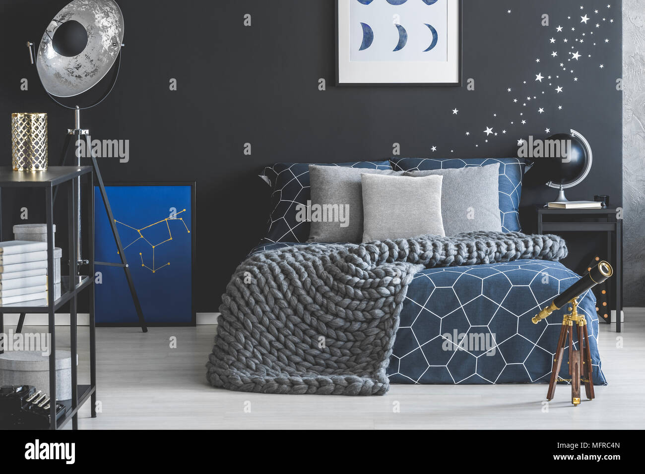 Grey and blue bed in spacious dark bedroom interior with black globe on  nightstand and telescope Stock Photo - Alamy, image size:1300x956