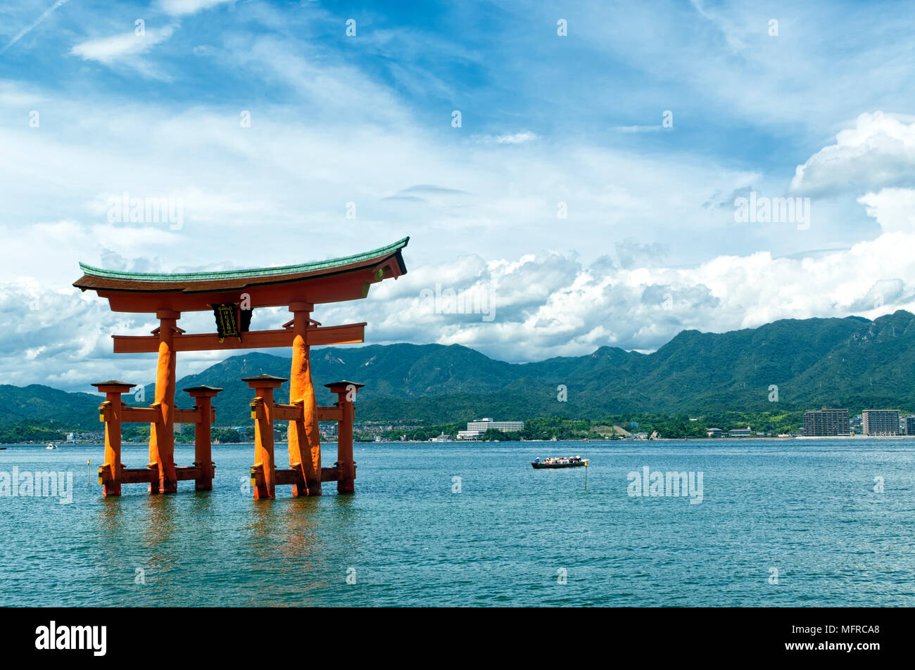 View of the torii (gate) of Itsukushima Shrine at high tide floating in the water of the island of Miyajima, Hiroshima Prefecture, Japan. Unesco site Stock Photo