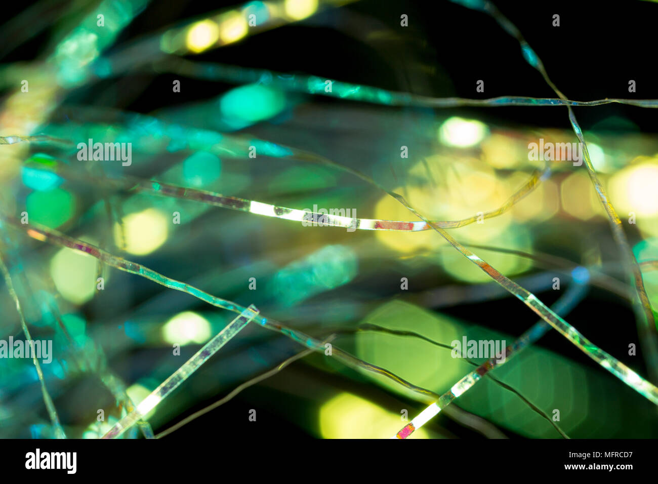 Flash material used in the making of fishing flies. Black background. England UK GB Stock Photo