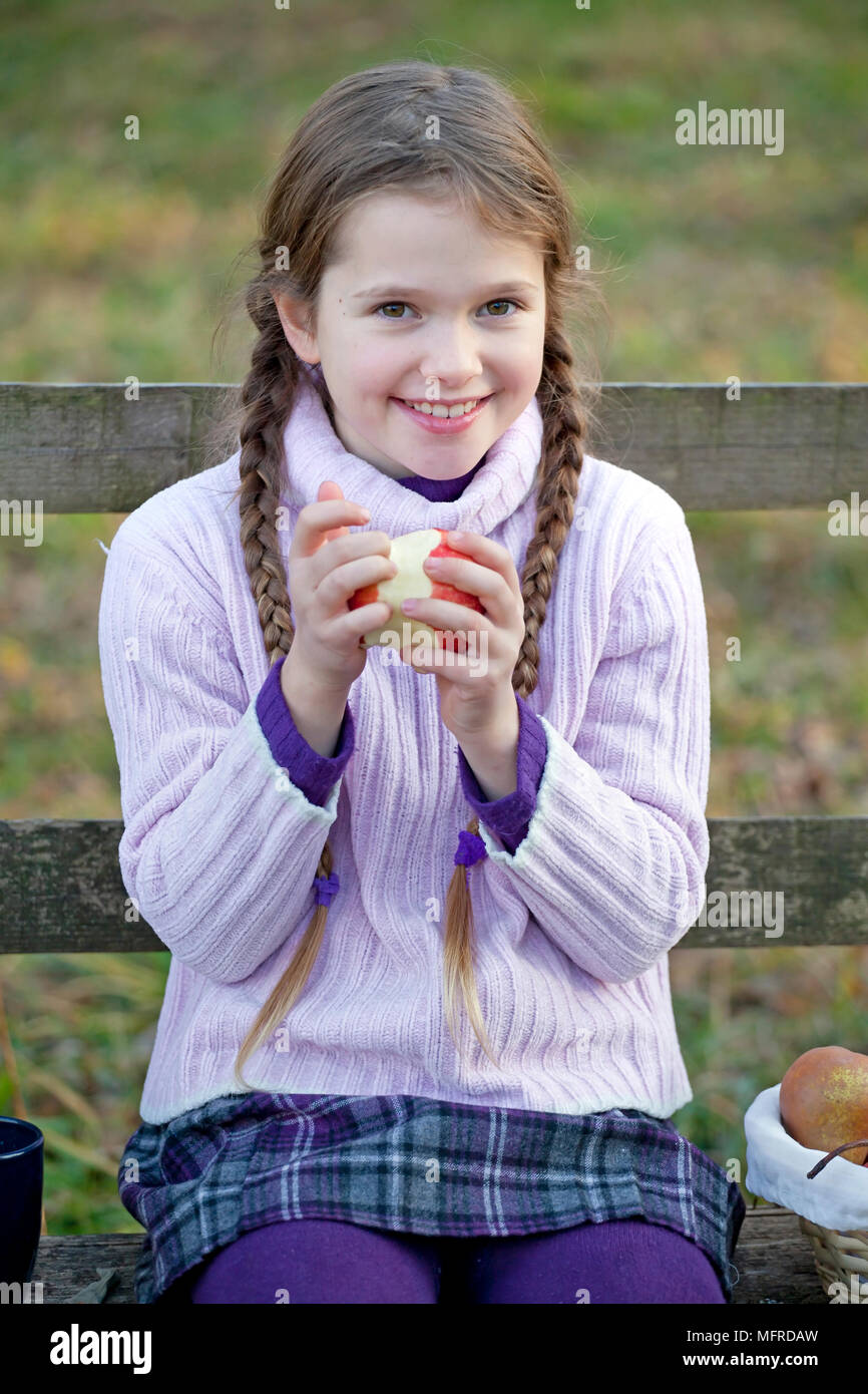 Girl pink dress sitting on bench hi-res stock photography and images ...