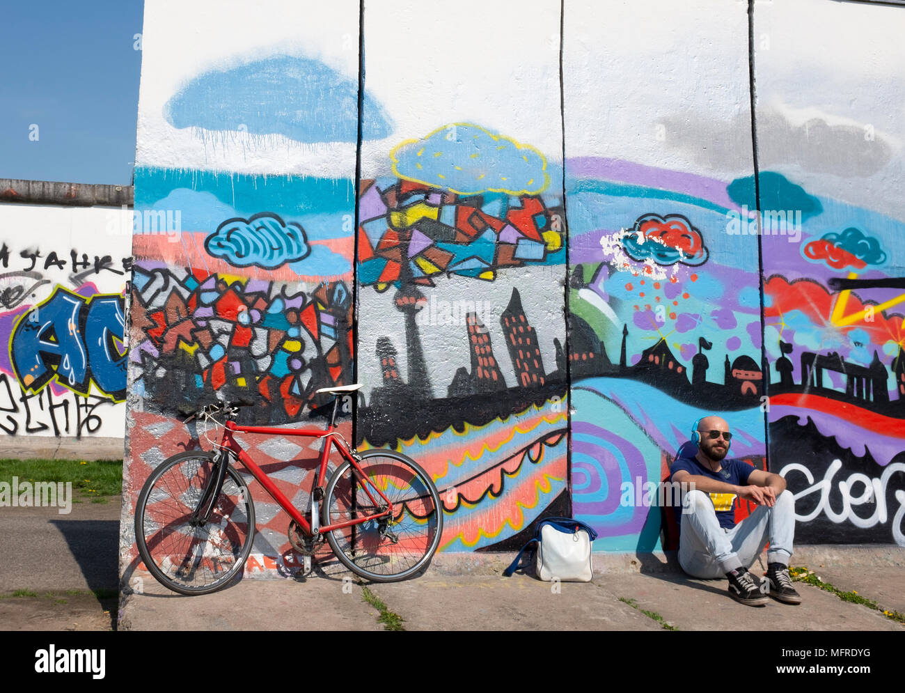 View of original section of Berlin Wall with graffiti at East Side Gallery in Friedrichshain, Berlin, Germany Stock Photo