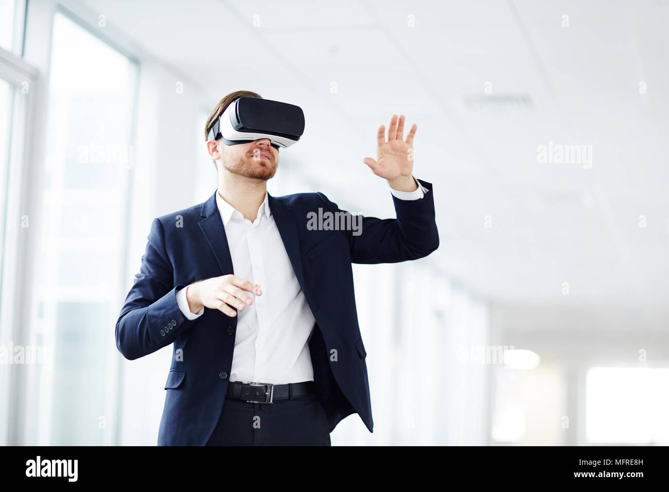 Young businessman using virtual reality technology at work Stock Photo