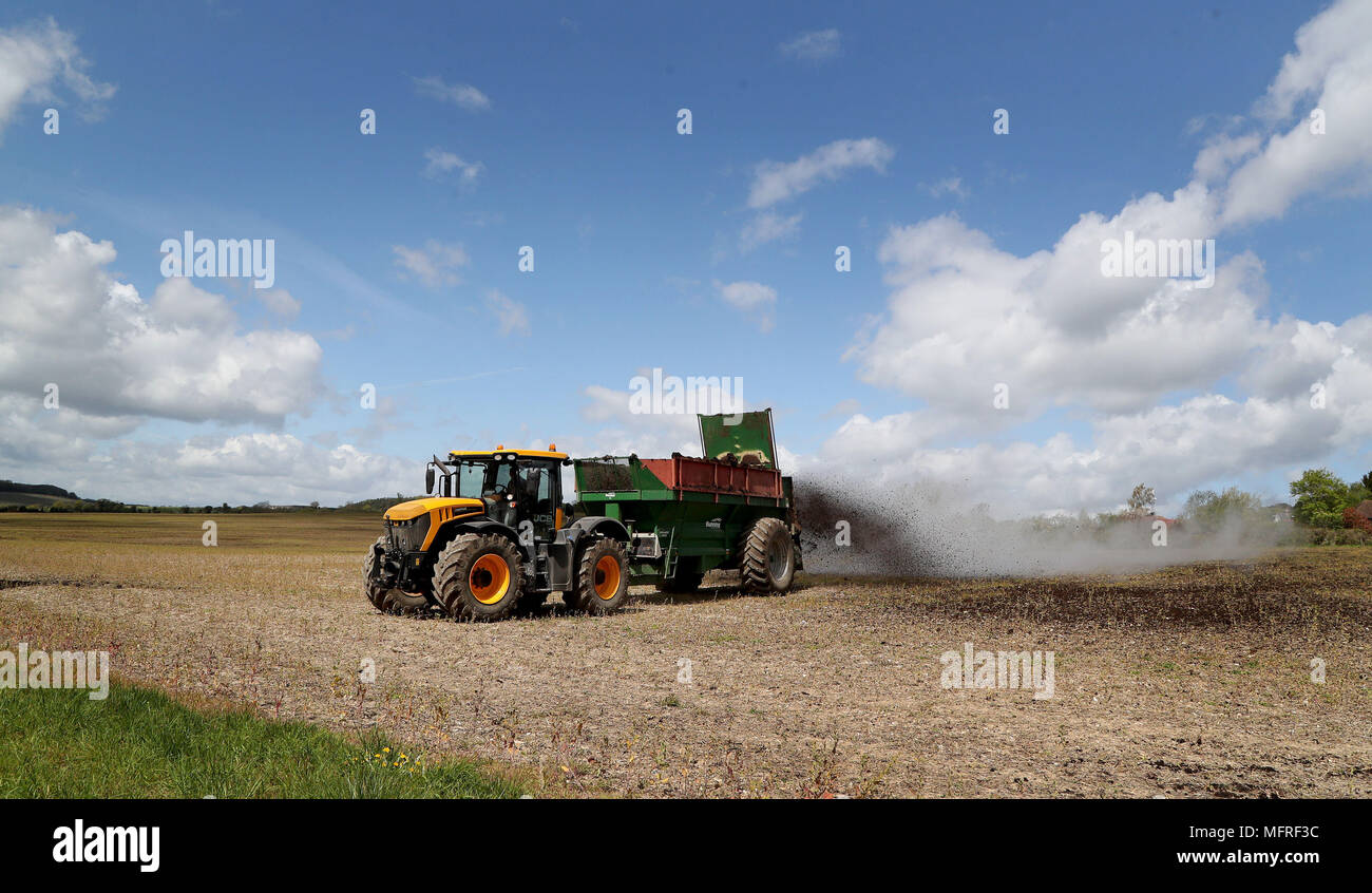 Farmer uses muck spreader to fertilise field near canterbury hires
