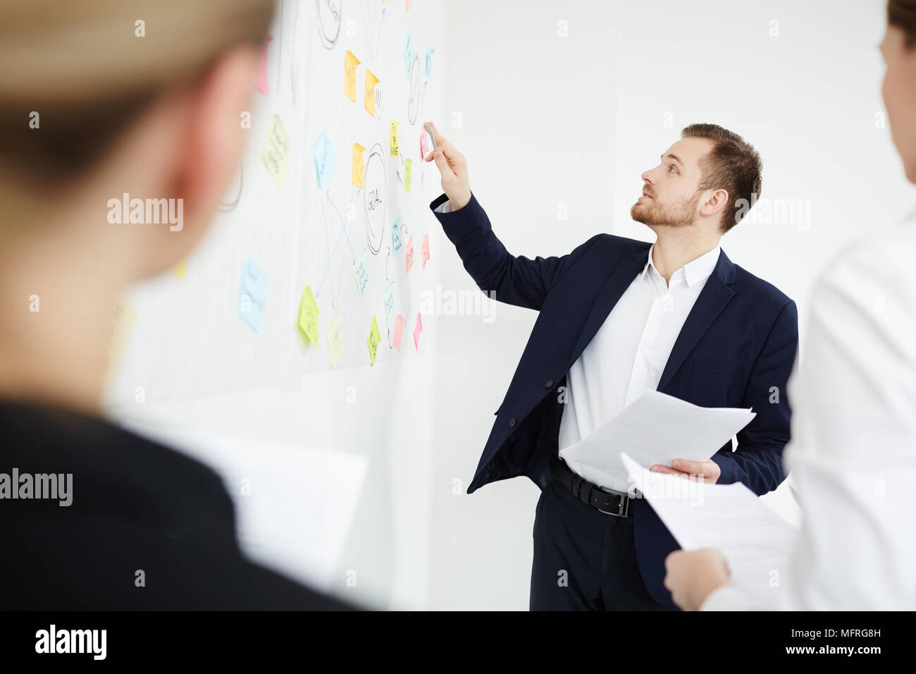 Young businessman explaining plan of the work at office Stock Photo