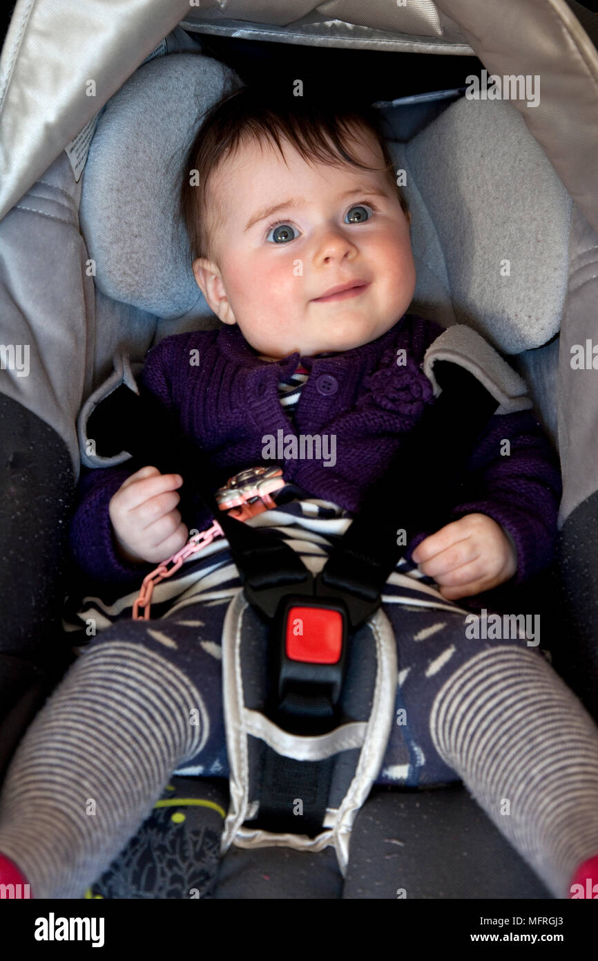 Baby strapped in a car seat. Model Release PS016 Stock Photo Alamy