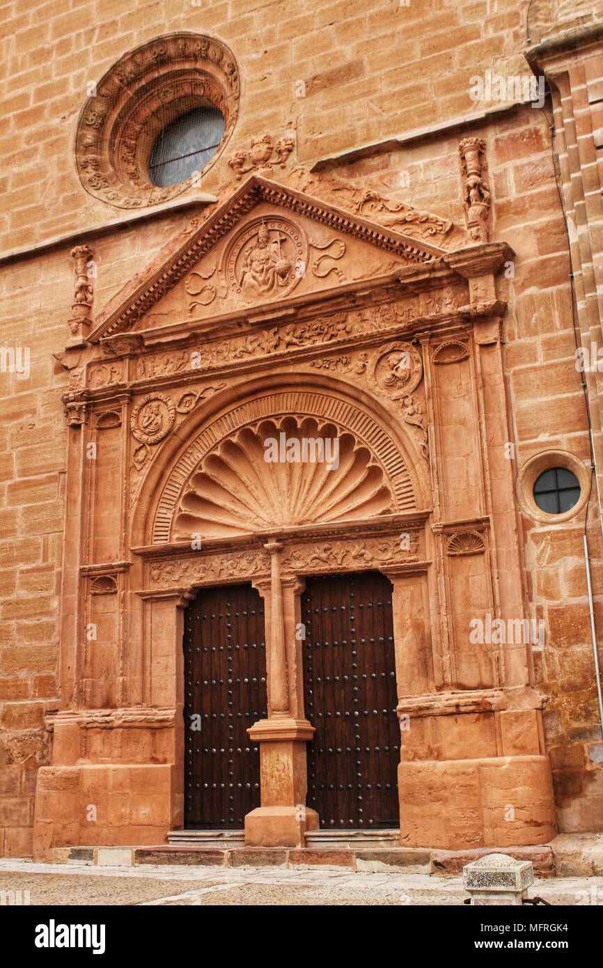 Old stone facade made of carved stone and vintage wooden door in a ...