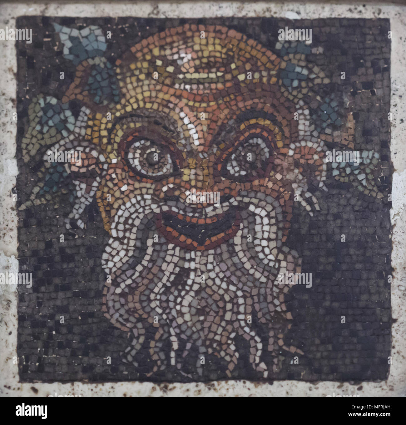 Theatrical mask depicted in the Roman mosaic from the Casa di Ganimede (House of Ganymede) in Pompeii, now on display in the National Archaeological Museum (Museo Archeologico Nazionale di Napoli) in Naples, Campania, Italy. Stock Photo