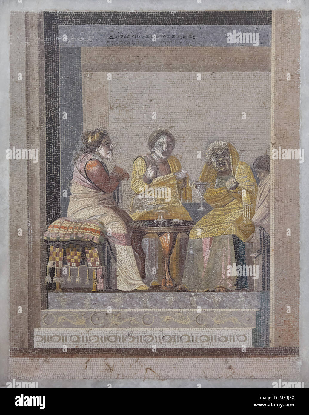 Comedy scene depicted in the Roman mosaic from Villa de Cicero (Villa of Cicero) in Pompeii, now on display in the National Archaeological Museum (Museo Archeologico Nazionale di Napoli) in Naples, Campania, Italy. Two women consulting with a witch are depicted in the mosaic. Signature on the top: signed by Dioskourides of Samos. Stock Photo