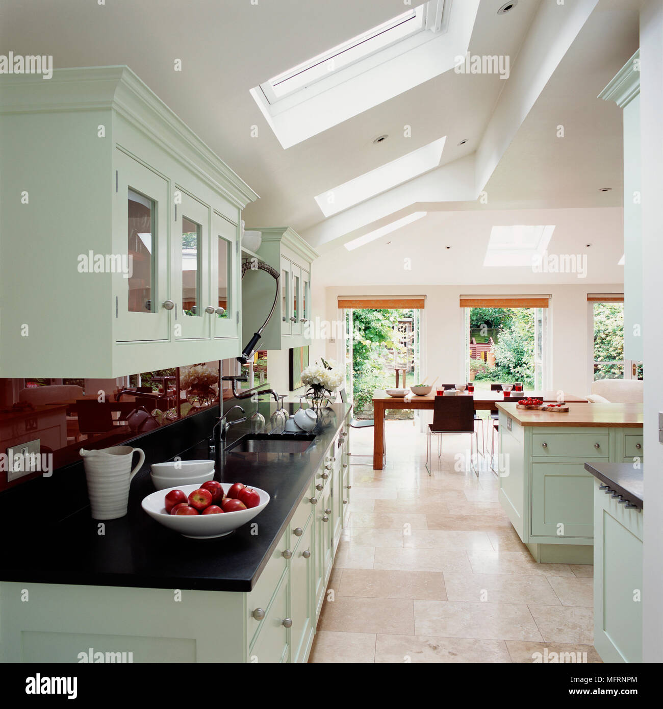Dining tale and chairs in modern country style kitchen with pale green ...