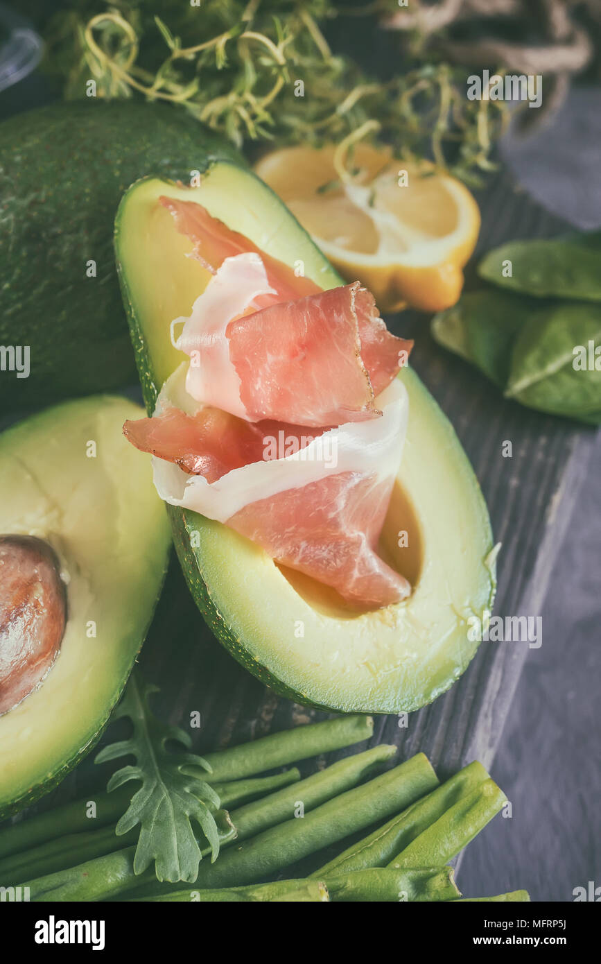 Avocado and prosciutto for making toast for Breakfast. The vertical