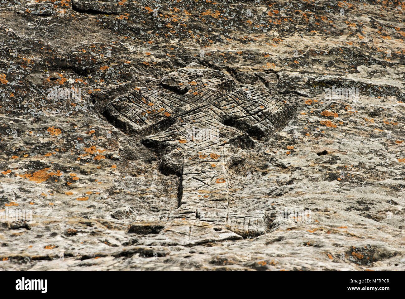 Ethiopian-orthodox cross carved in stone, at the orthodox rock church Mikael Mellehayzengi, Tsaeda Amba, Tigray, Ethiopia Stock Photo