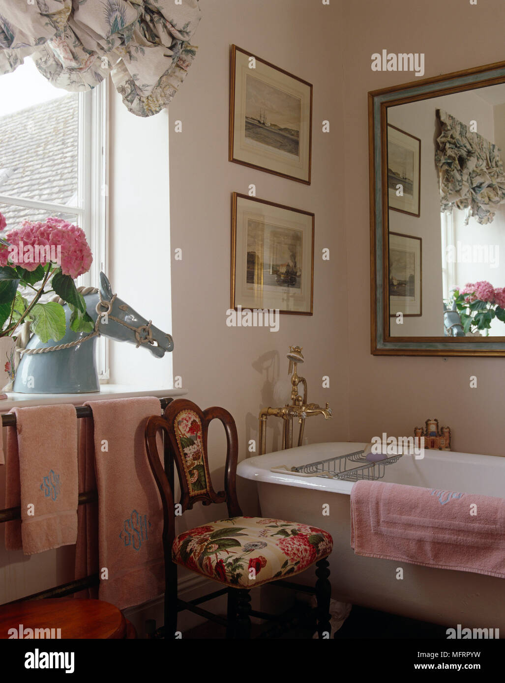Period style freestanding bathtub in pink bathroom Stock Photo Alamy
