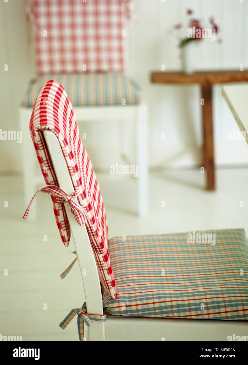 White wood chair with check pattern covers Stock Photo