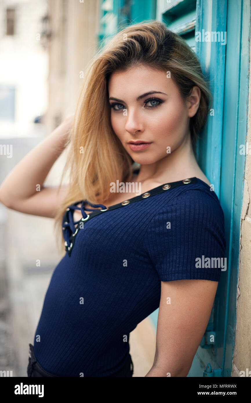 Blue eye model with blond hair with street in the background Stock Photo