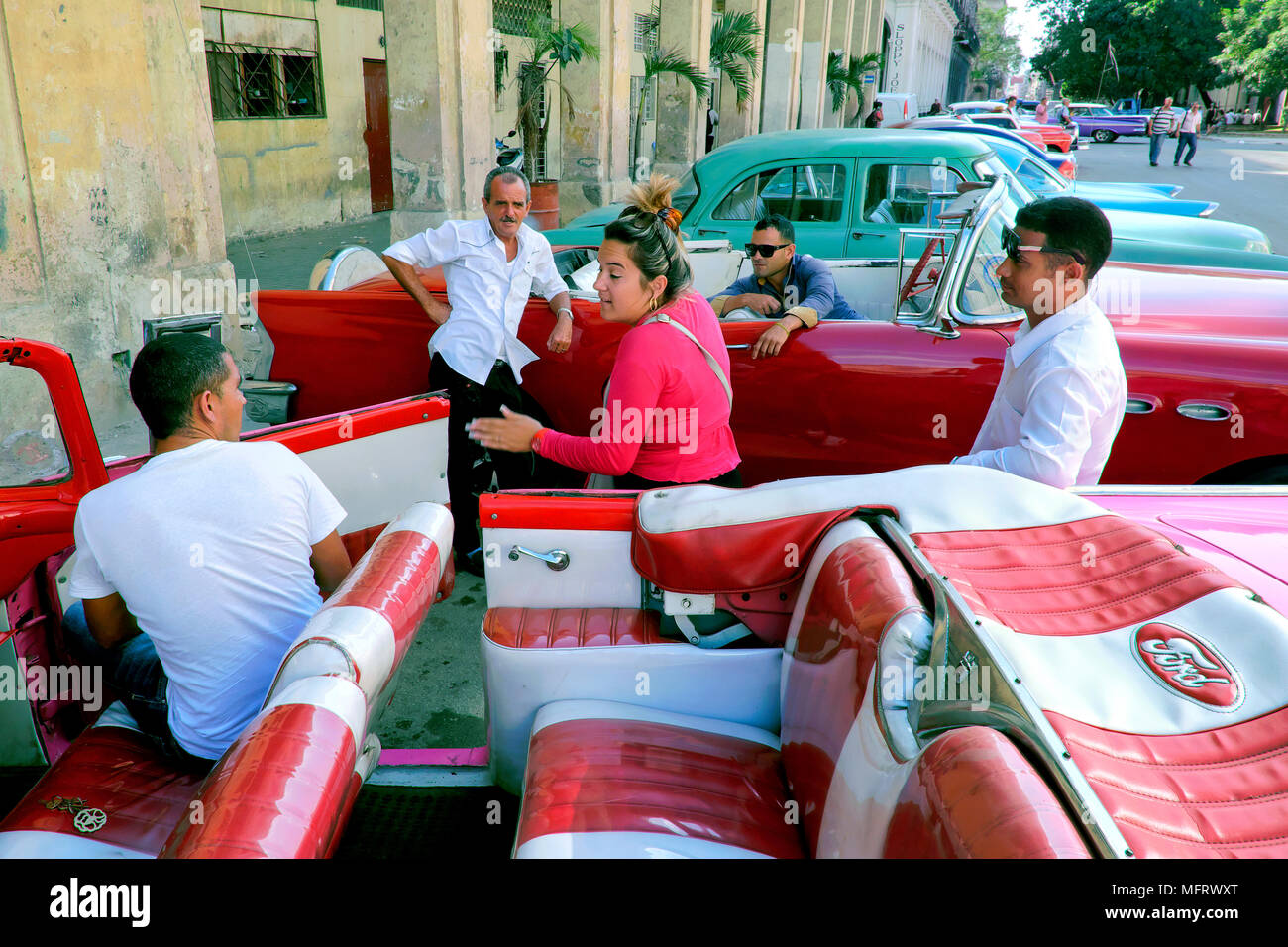 Small talk between tourist taxi drivers, Old Havana, Cuba Stock Photo