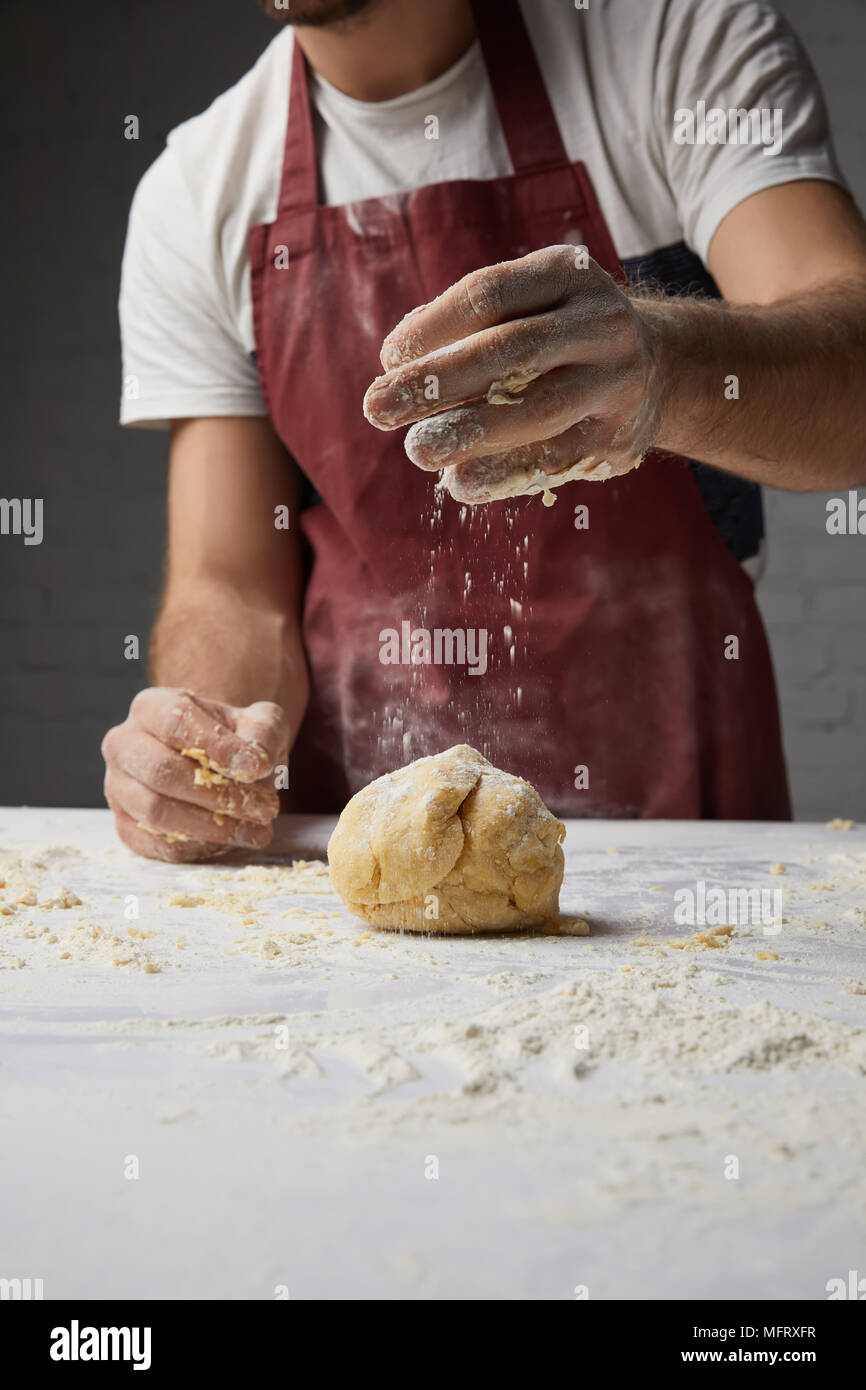 cropped image of chef preparing dough in kitchen Stock Photo