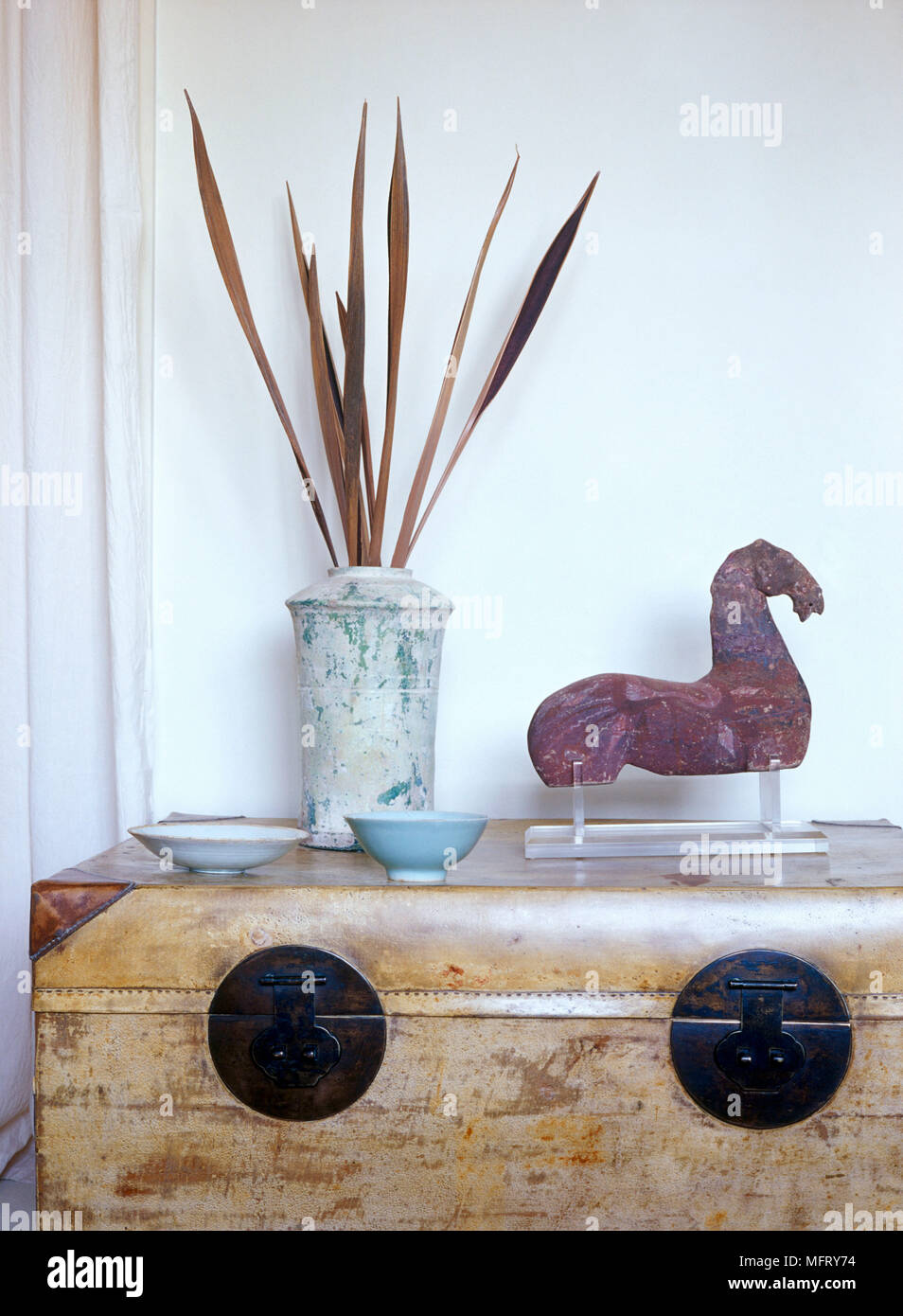 A Detail Of A Rustic Trunk A Pottery Vase Ceramic Dishes And A