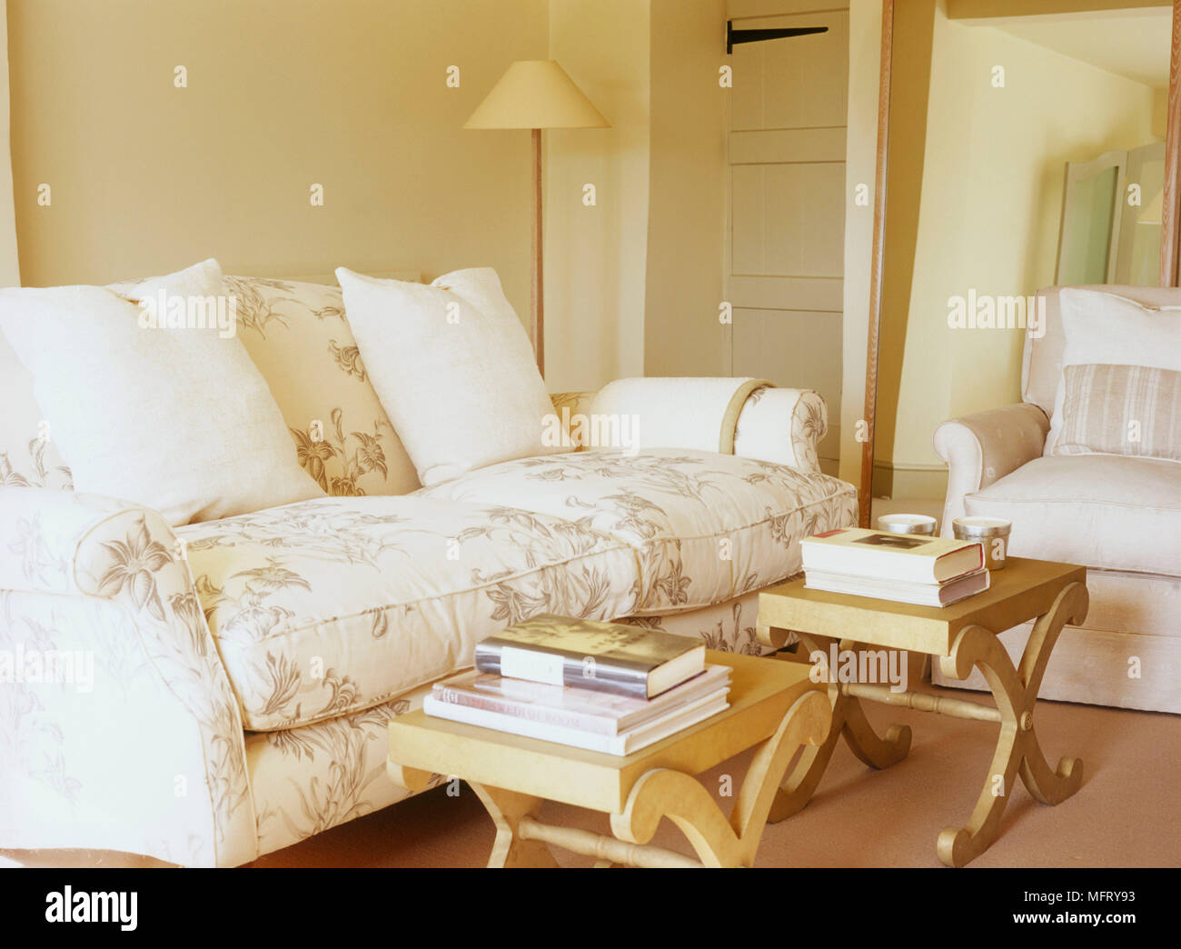 A detail of a traditional sitting room with upholstered sofa and ...