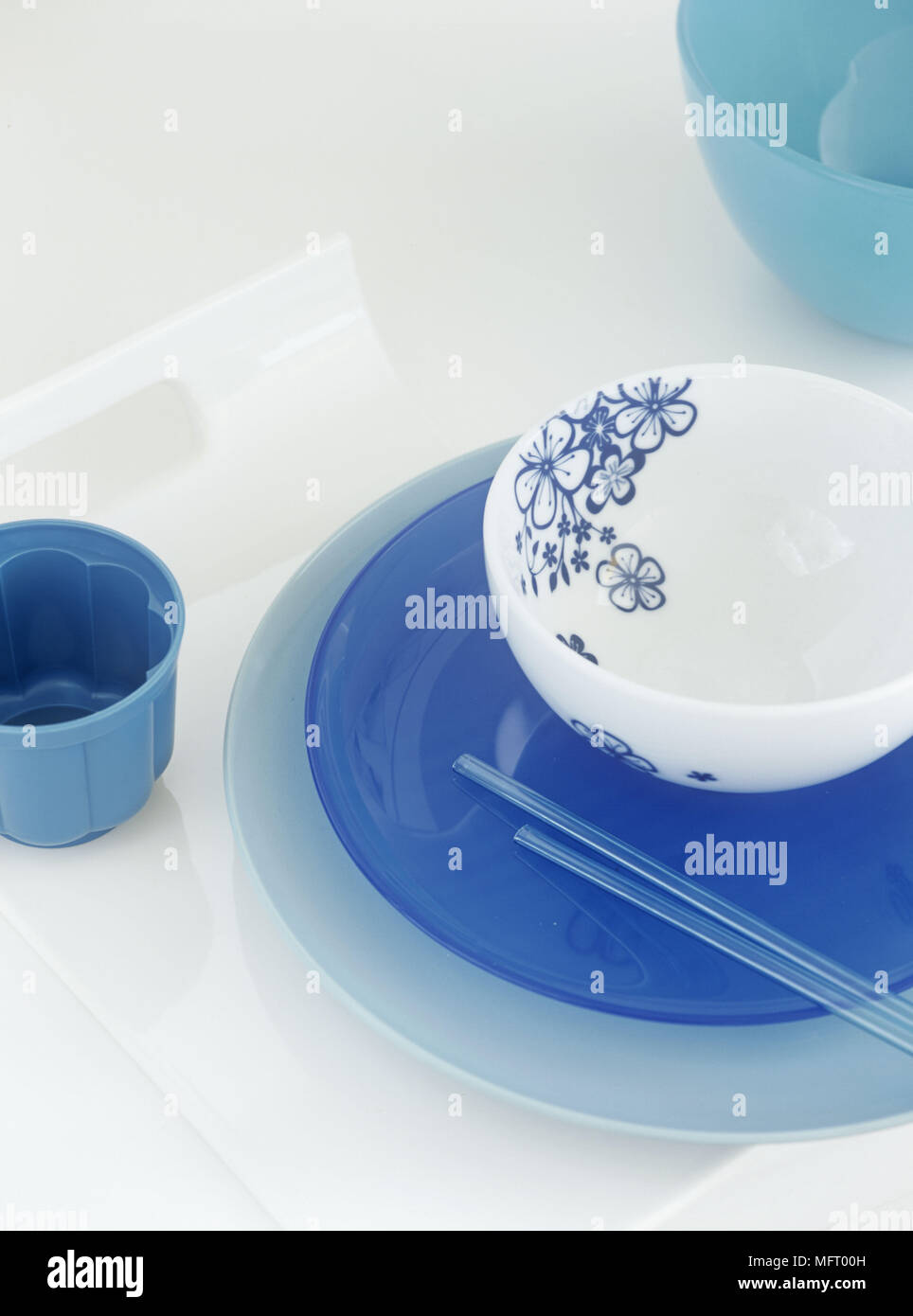 Blue plates and white decorative bowl with chopsticks Stock Photo
