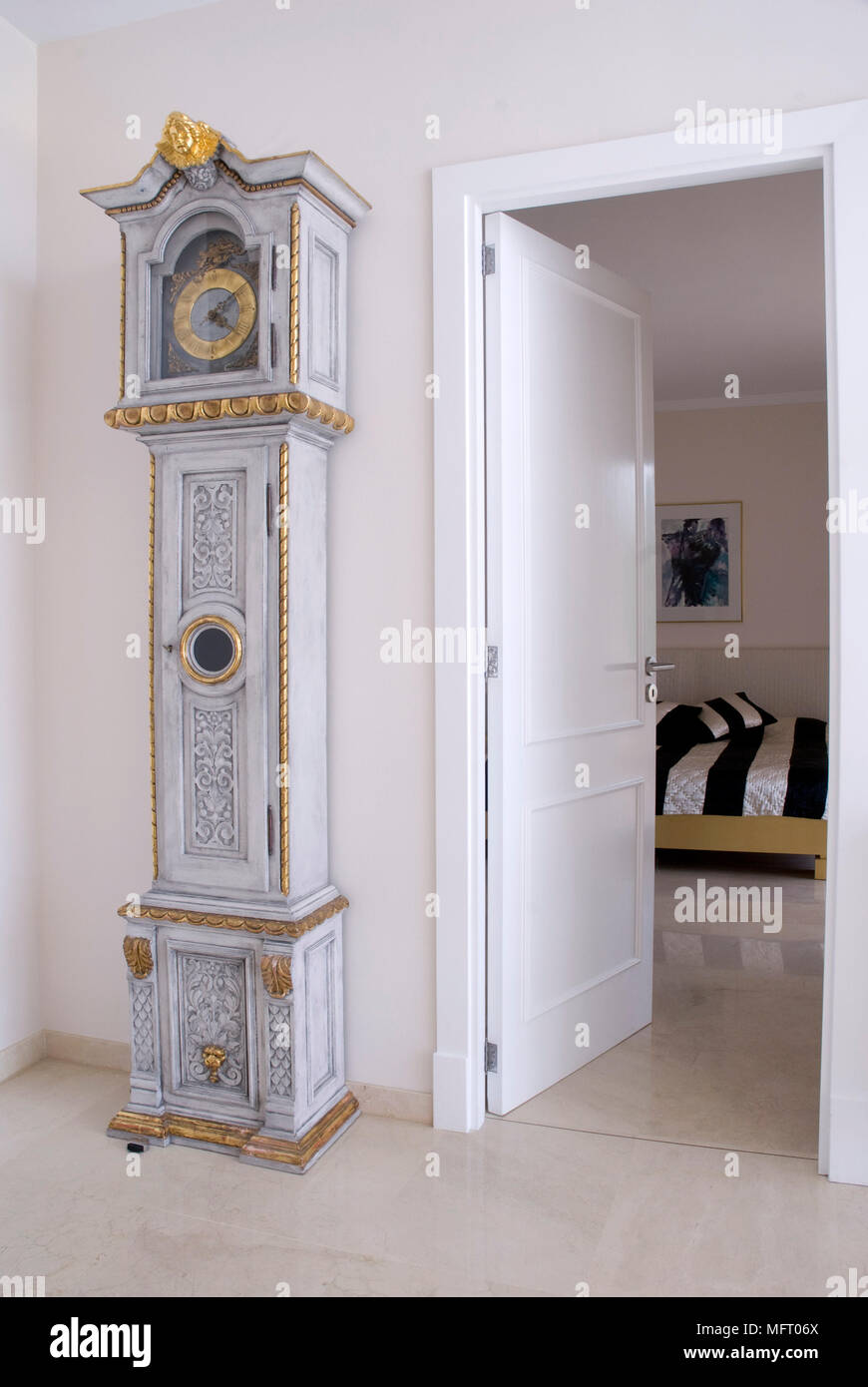 Ornate grandfather clock to the side of open door Stock Photo Alamy