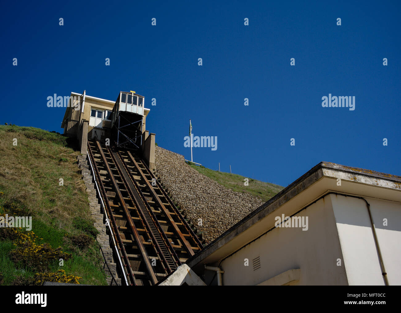 Fisherman walk, Bournemouth, funicular railway cliff lift and toll station  looking at track with a solid blue sky on a sunny day with copy space. Stock Photo