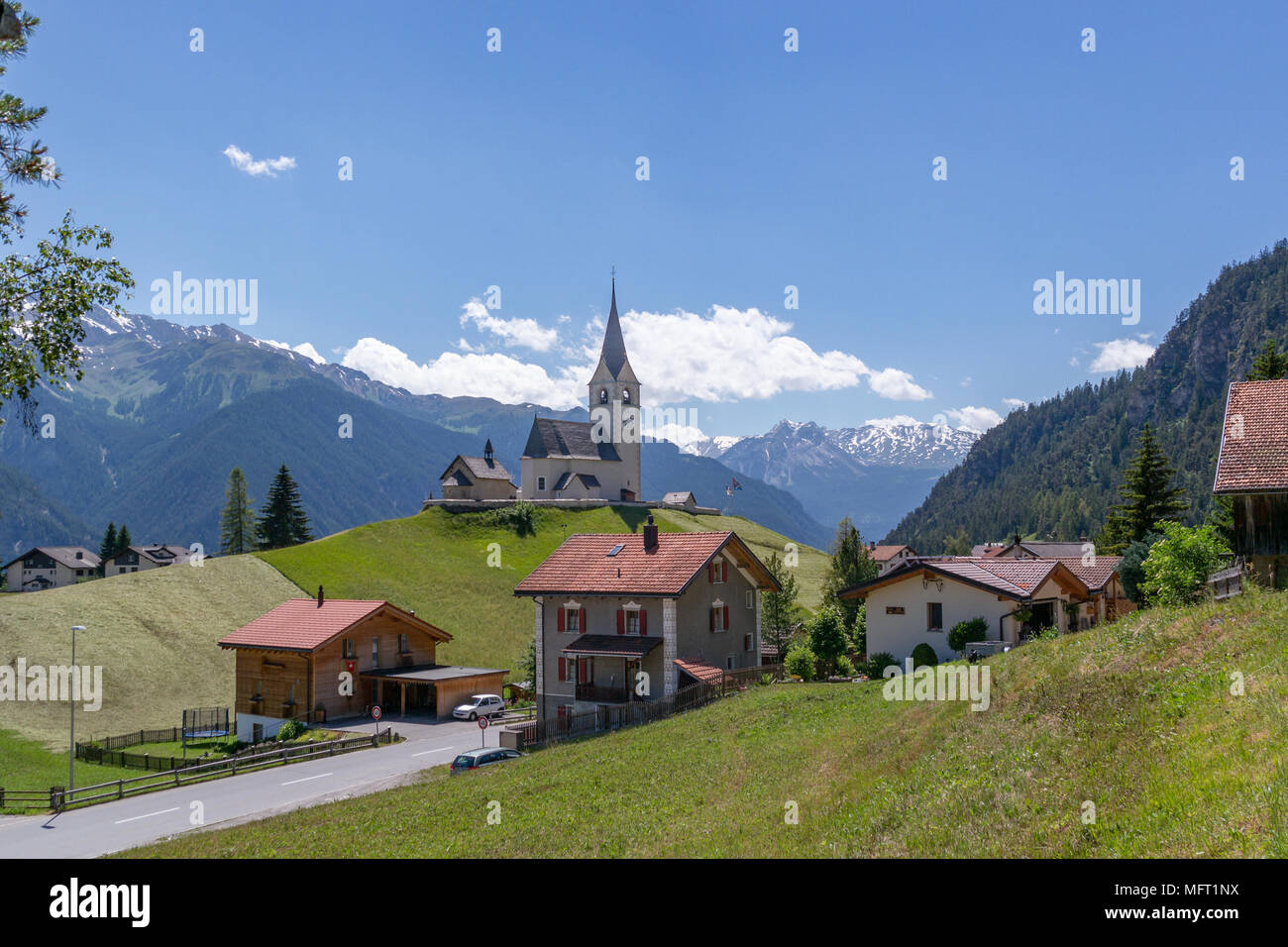View on a church and some houses in Schmitten on the road from Wiesen to Alvaneu. Stock Photo