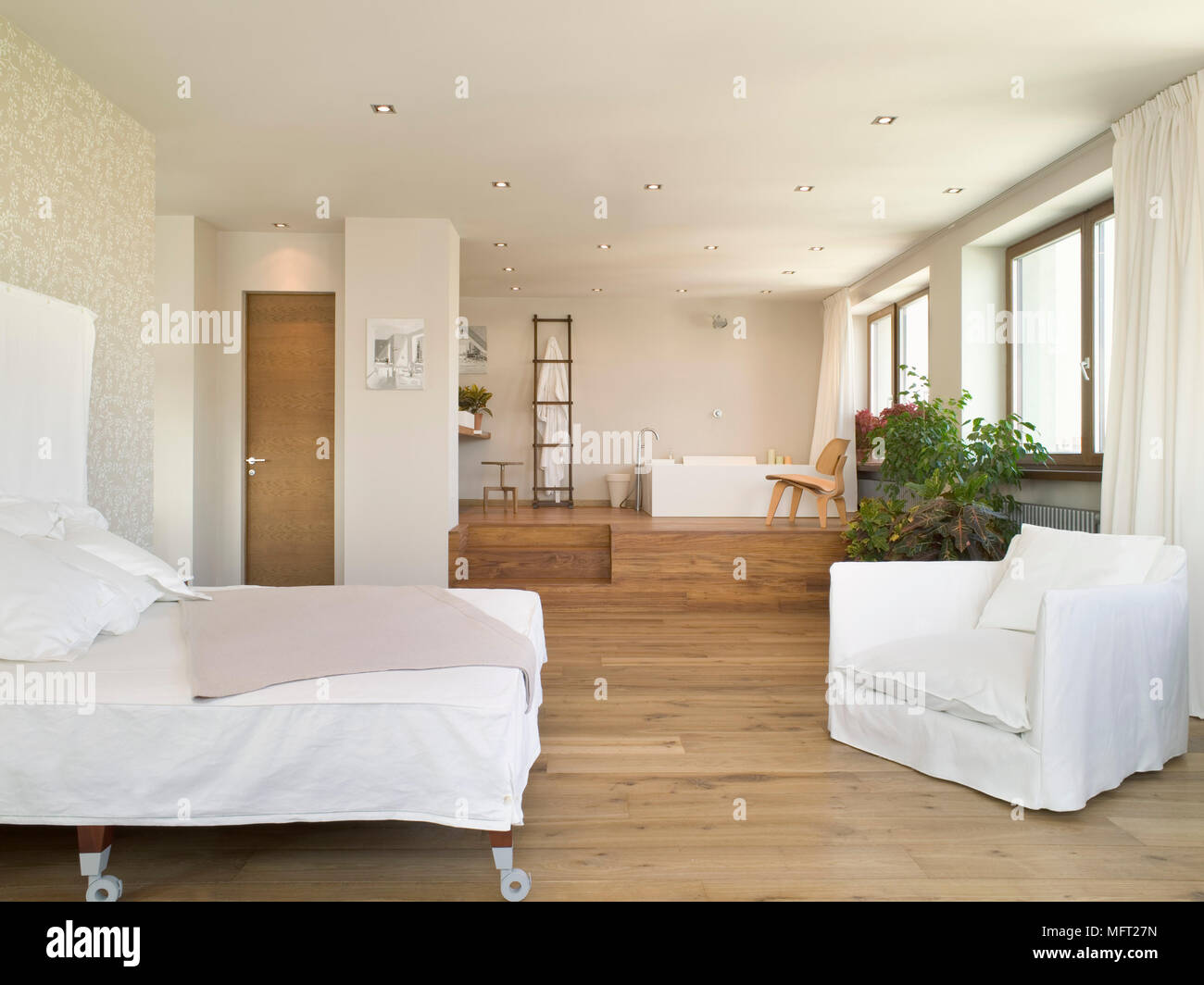 Open Plan Bedroom With Wooden Floor And Double Bed With