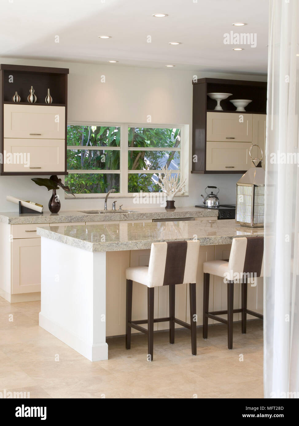 Modern Kitchen With Stools At Breakfast Bar With Polished Granite