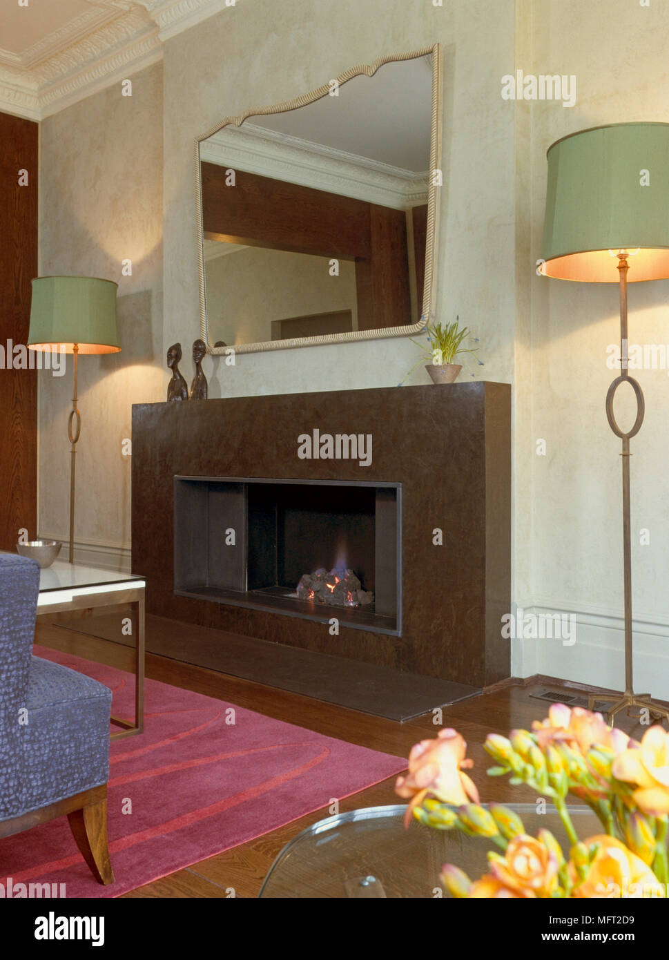 Pair of lamp standards either side of fireplace Stock Photo Alamy