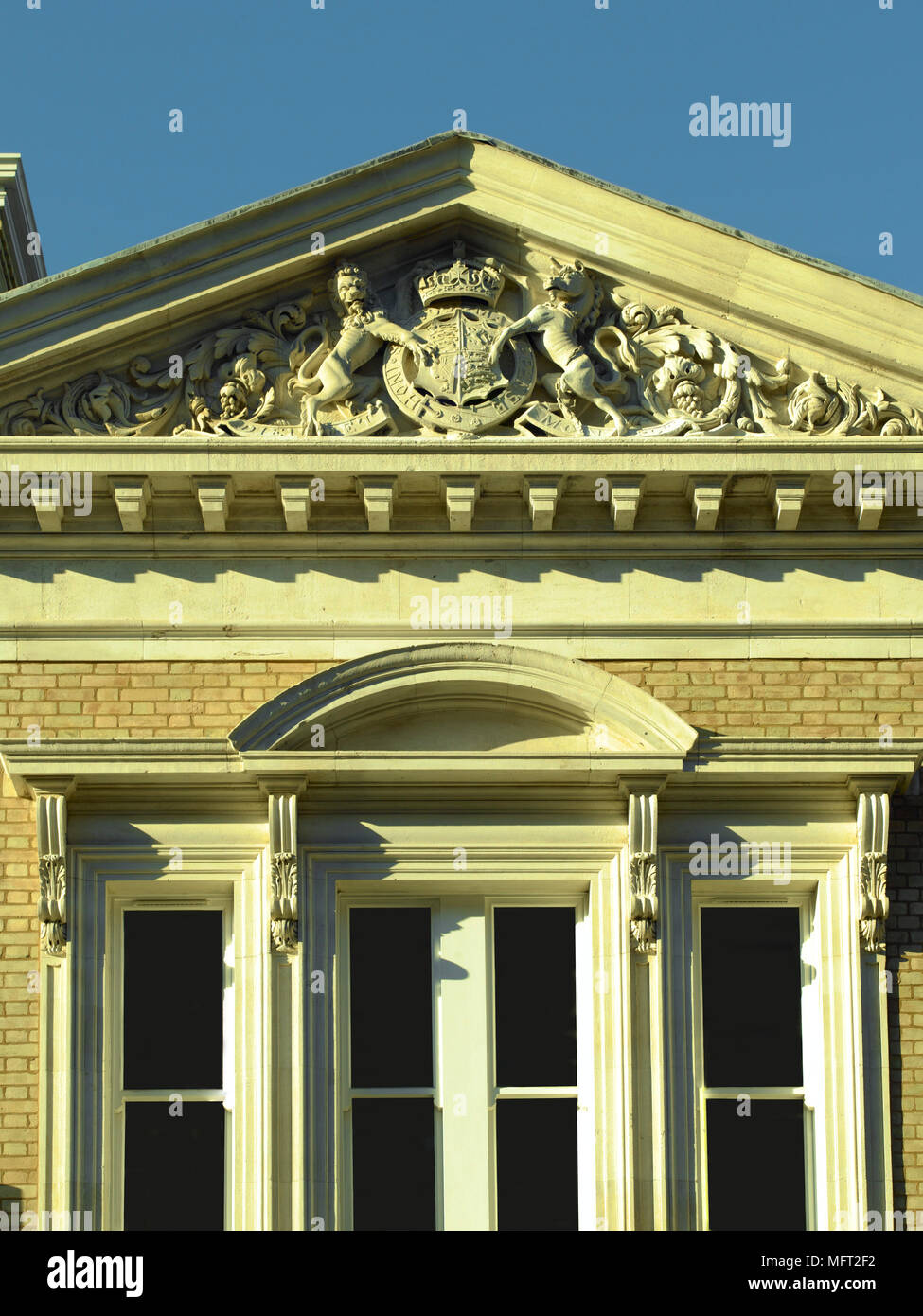 Exterior of a building with a stone pediment and sculptured
