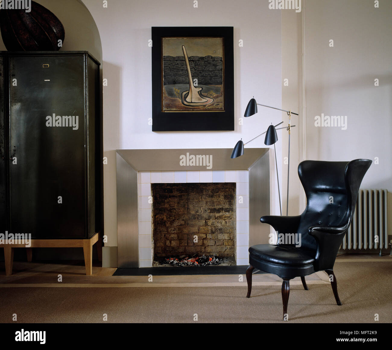 Modern neutral sitting room with leather armchair in front of metal