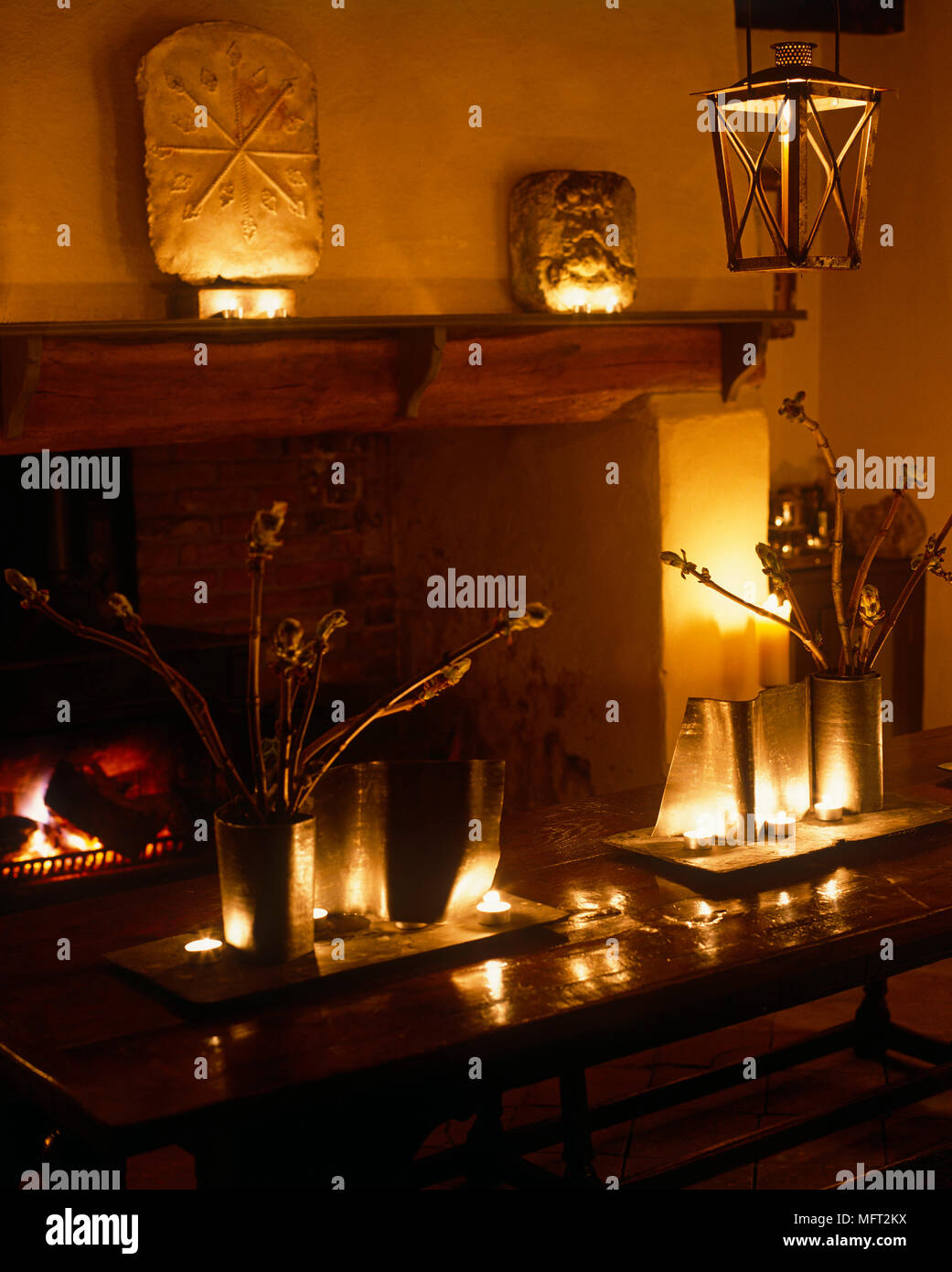 Stone fireplace surrounded by lit candles Stock Photo