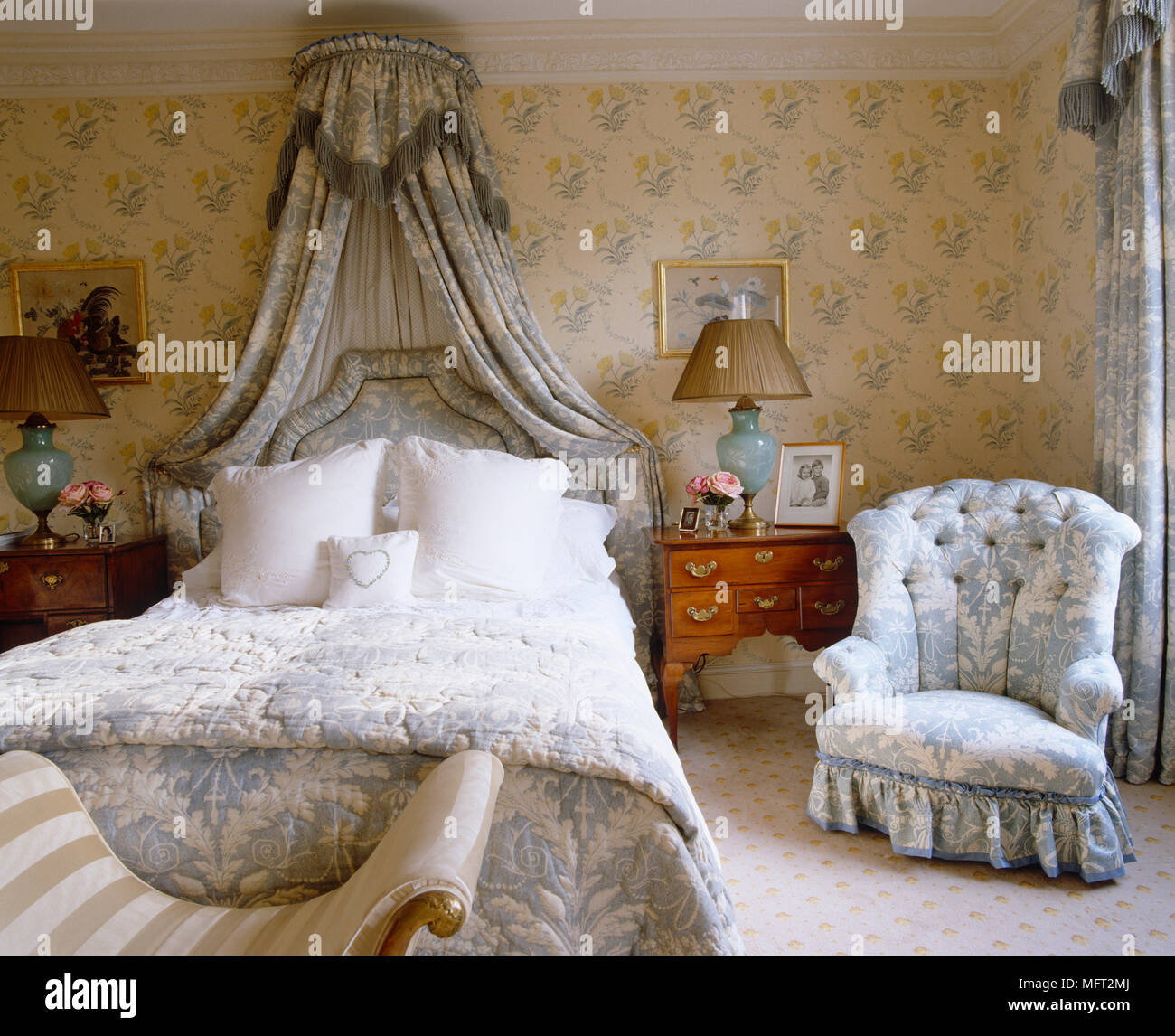 Double bed with canopy overhead and coordinated curtains Stock Photo ...