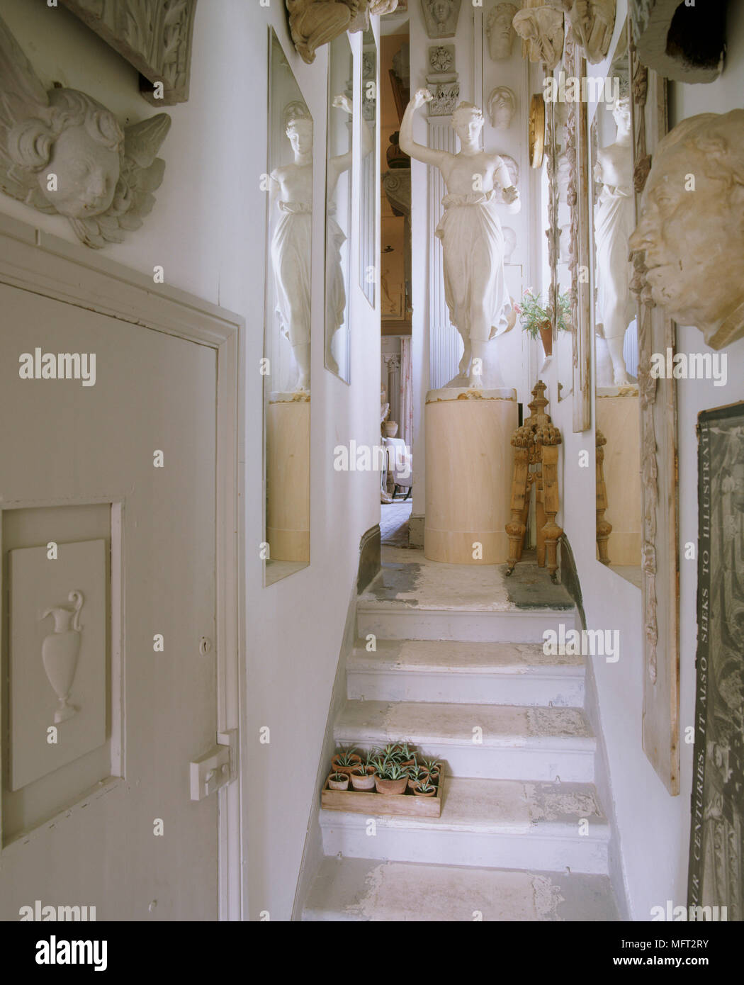 A detail of stone stairs, classical statue on plinth and a display of stone and plaster work, friezes and sculptures, Stock Photo