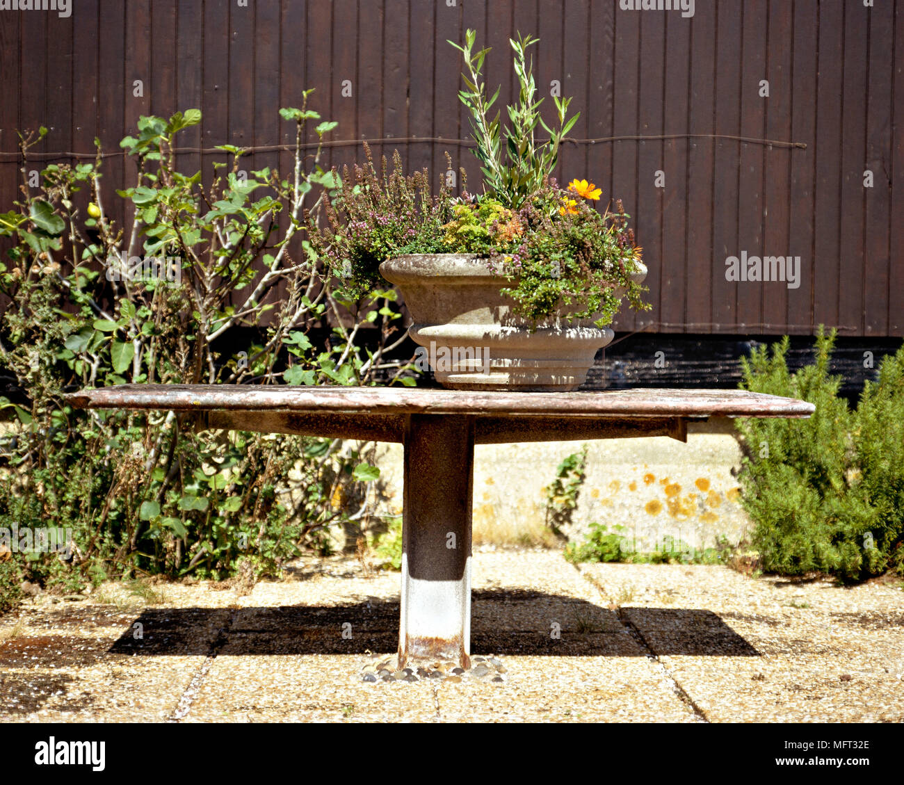 Rustic outdoor metal table planters outdoors outside furniture Stock