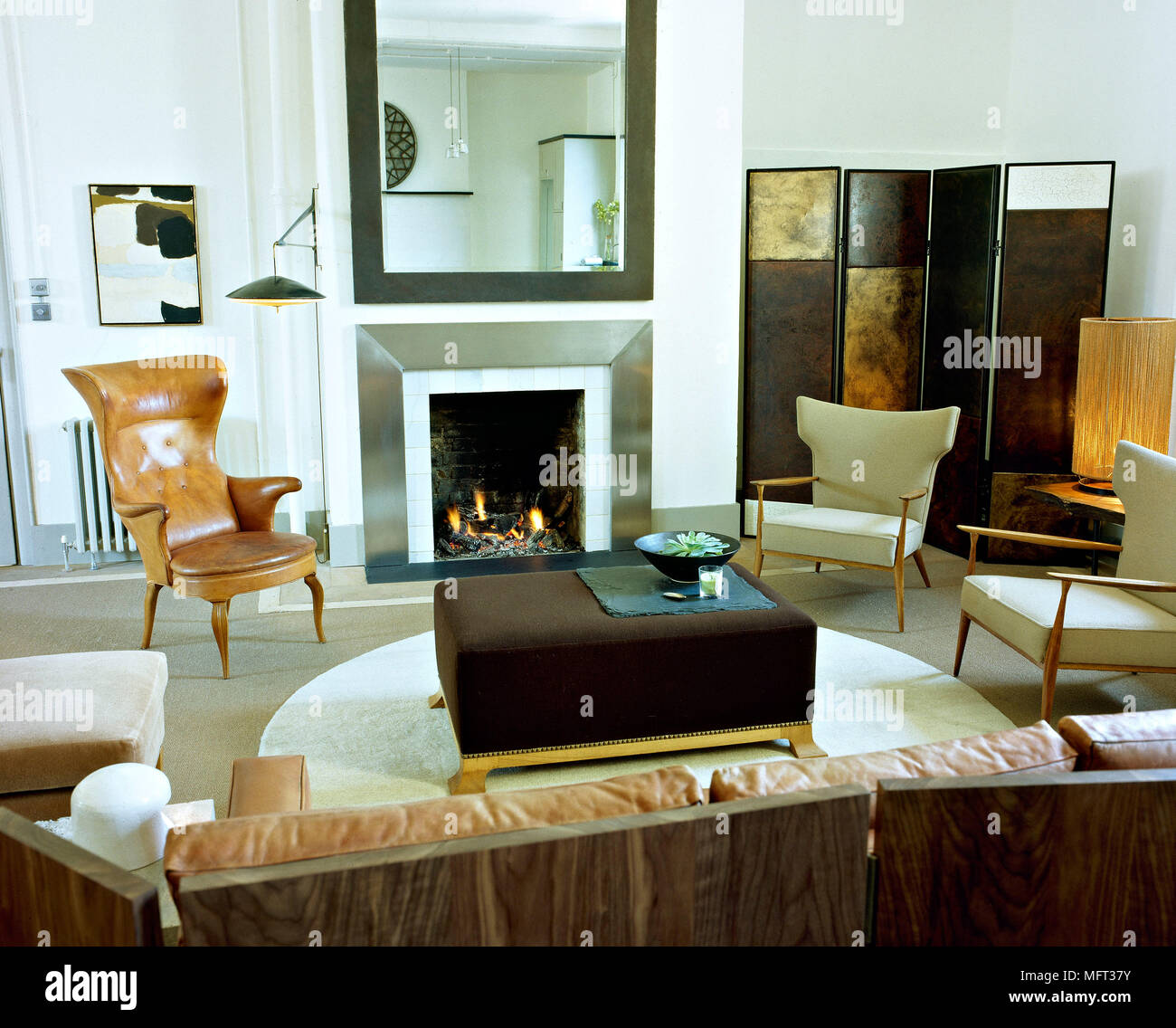 Modern sitting room fireplace lit fire metal surround brown leather ... Modern sitting room fireplace lit fire metal surround brown leather ...