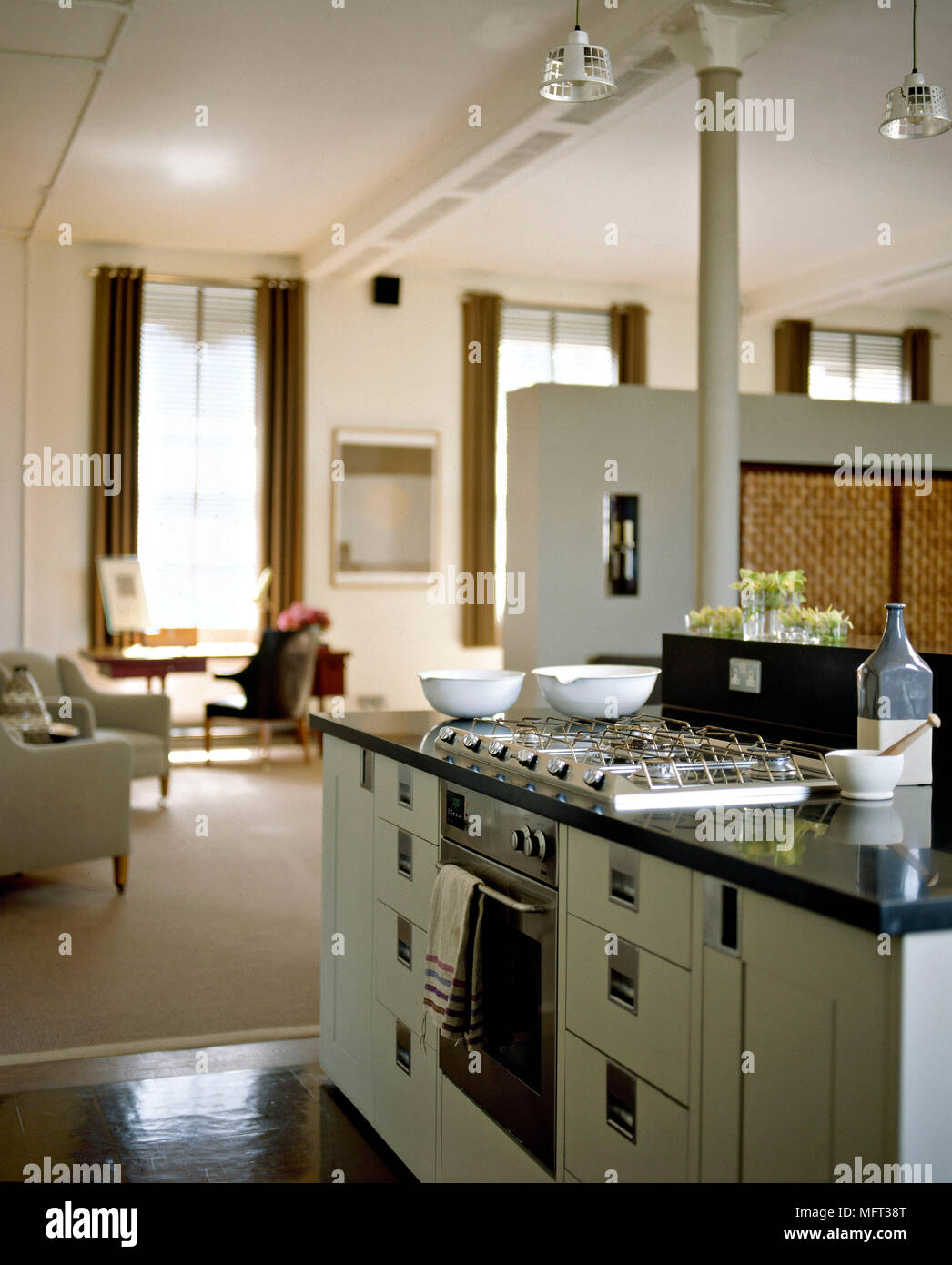 Modern open plan sitting room kitchen area central island unit gas hob