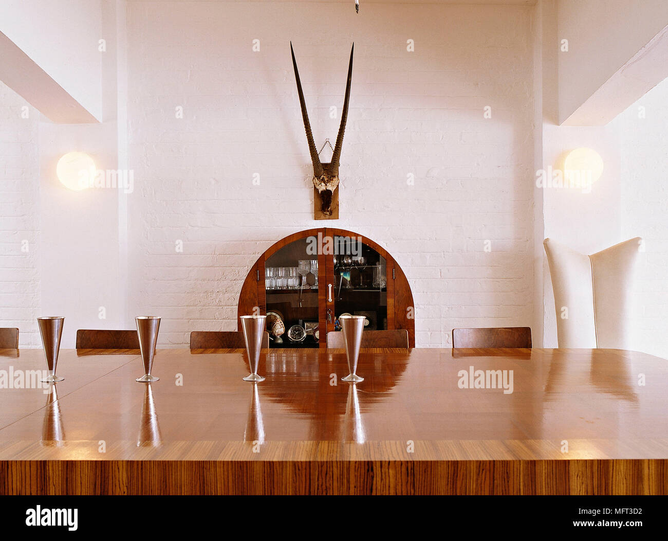 Modern dining room wood inlaid table interiors detail furniture Stock