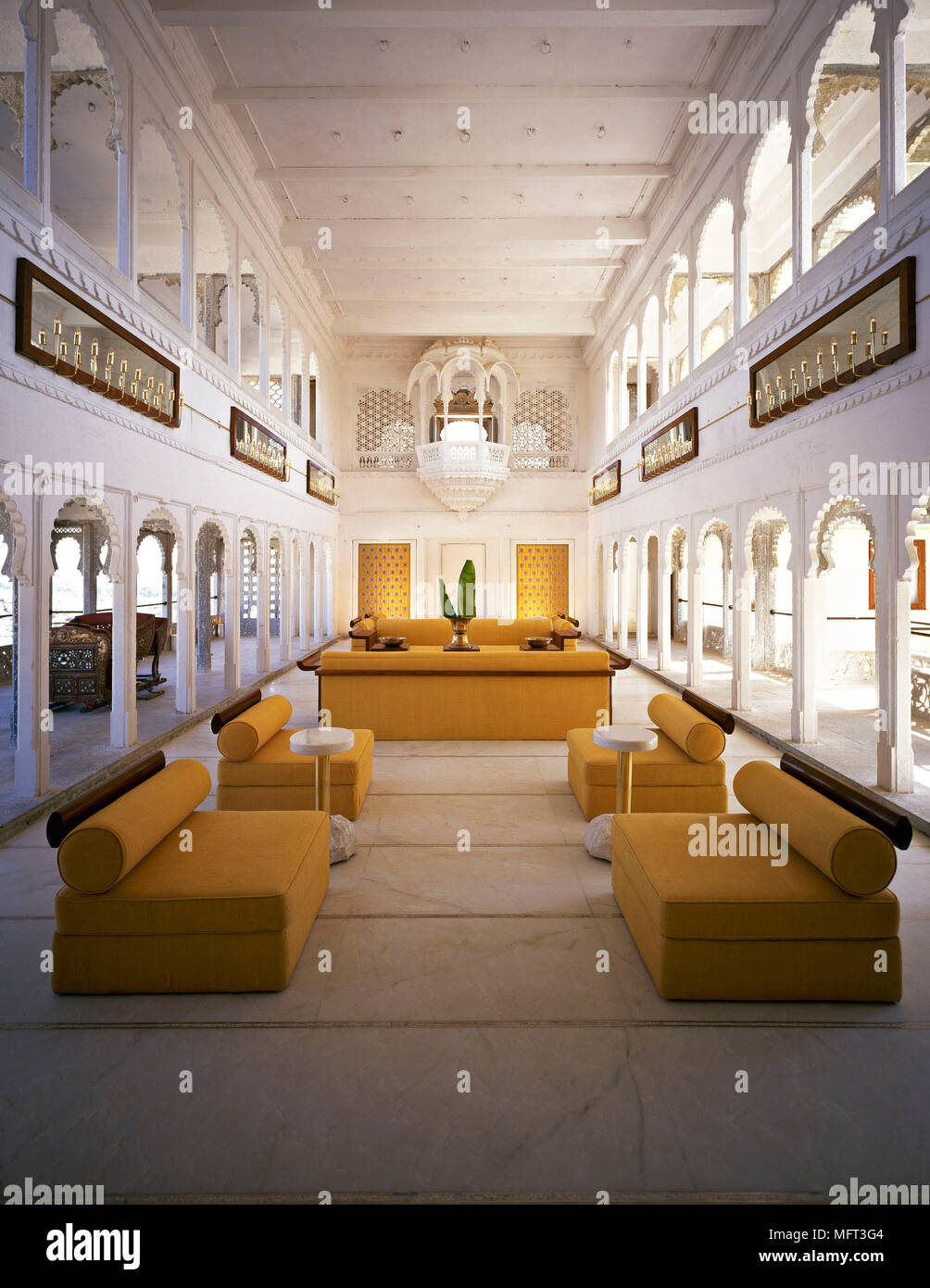 Hotel lounge area archways chairs and sofas marble floor balconies