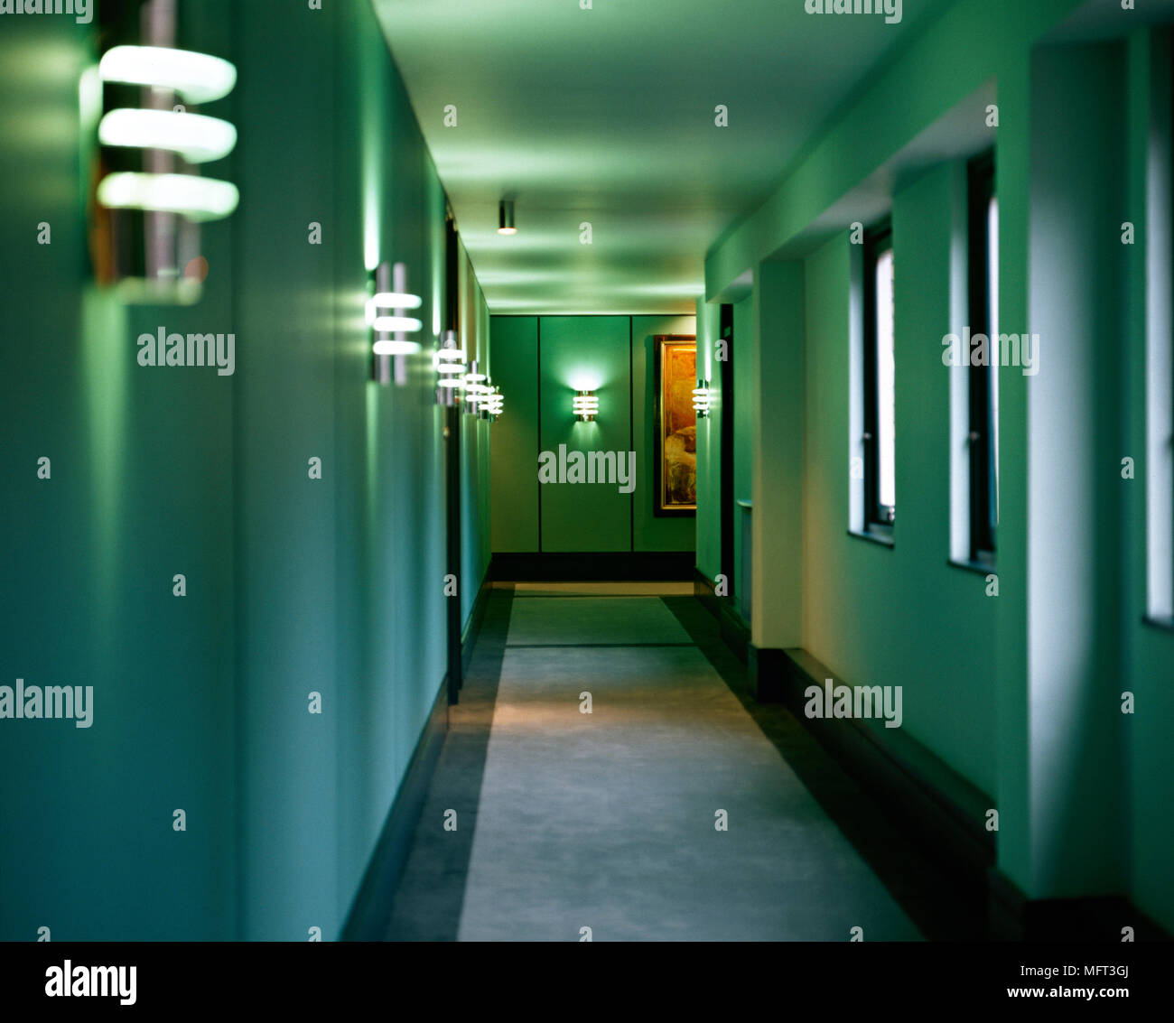 Hallway to modern apartment lit wall lights  Interiors halls hallways apartments Stock Photo
